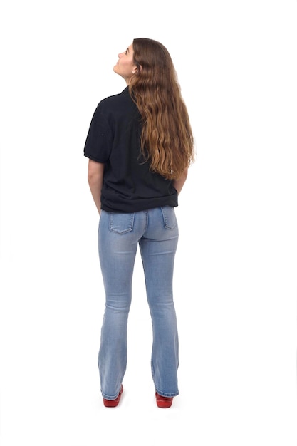 Back view of young girl looking up on white background