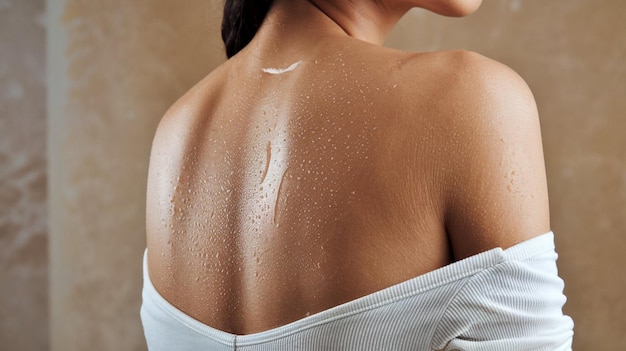 the back of a woman  s back with water drops on the back