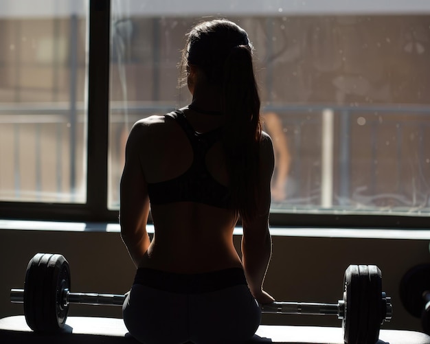 Back Workout HispanicLatino Young Woman Doing Dumbbell Row Exercise on Bench at Gym