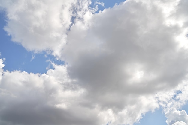 Backdrop of a white cloud in a blue summer sky Natural background with soft clouds