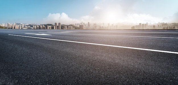 Background of asphalt pavement and urban architectural landscape skyline