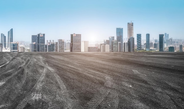 Background of asphalt pavement and urban architectural landscape skyline