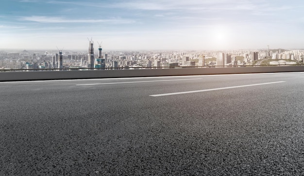 Background of asphalt pavement and urban architectural landscape skyline