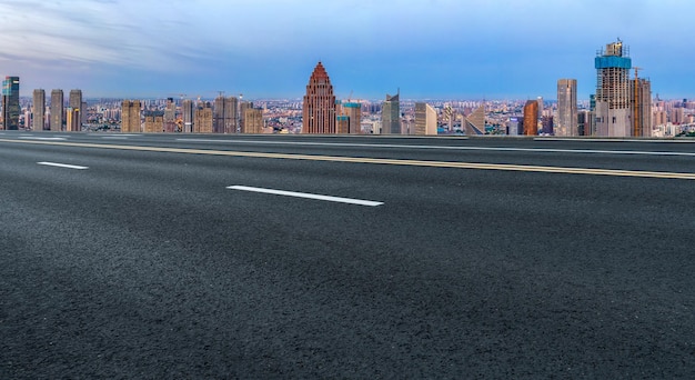 Background of asphalt pavement and urban architectural landscape skyline