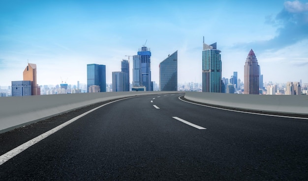 Background of asphalt pavement and urban architectural landscape skyline