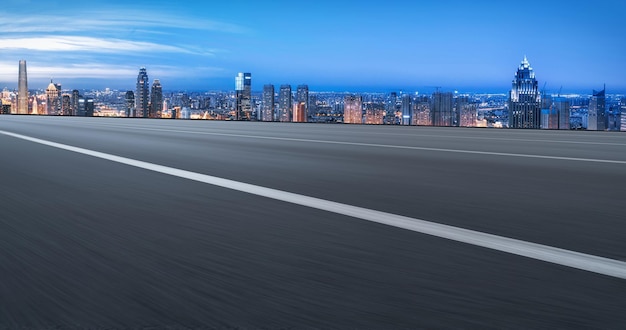 Background of asphalt pavement and urban architectural landscape skyline