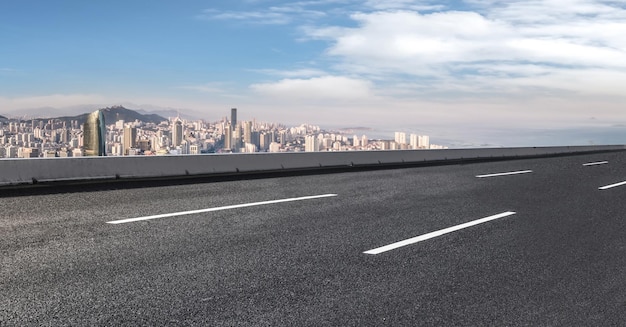 Background of asphalt pavement and urban architectural landscape skyline