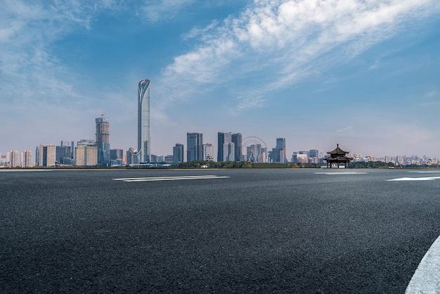 Background of asphalt pavement and urban architectural landscape skyline