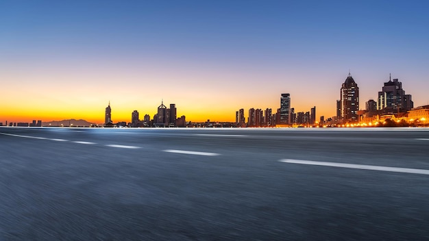 Background of asphalt pavement and urban architectural landscape skyline