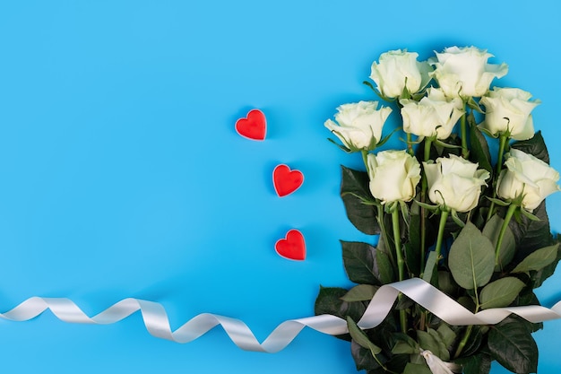 Background for banners beautiful boquet of white rose ribbon isolated blue background with copyspace