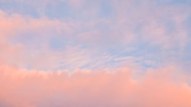 Background of blue sky with pale pink clouds in sunset