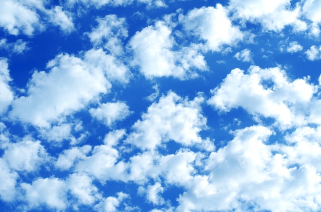 Background of blue sky with white and gray clouds.