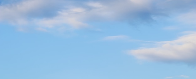 Background of blue sky with white and pink clouds in sunset