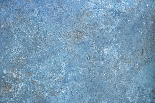 Background of a blue stucco coated and painted exterior rough cast of cement and concrete wall texture decorative coating