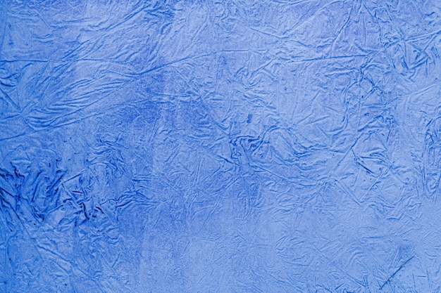 Background of a blue stucco coated and painted exterior, rough cast of cement and concrete wall texture