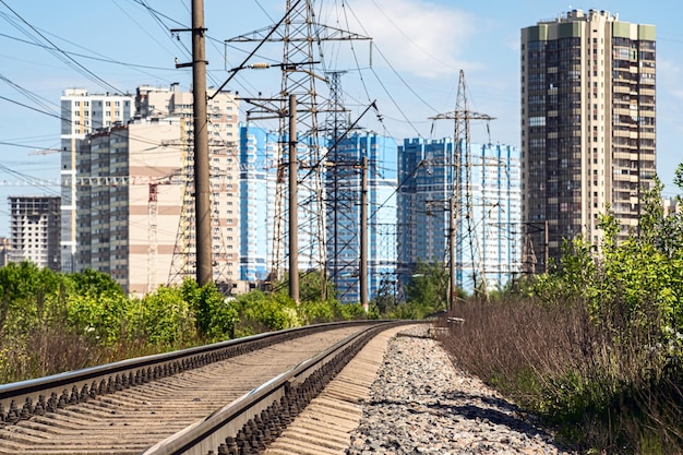 Background, blur, out of focus, bokeh. Railway in the city. Soft sunlight is reflected in the windows of city houses.