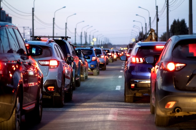 Background, blur, out of focus, bokeh. Traffic jams, road repairs, or accidents. Red brake lights of stopped cars.