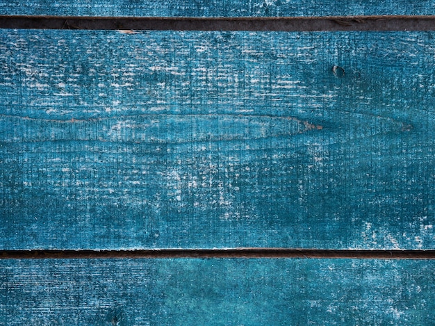 Background the board is painted with blue paint, the board is placed horizontally, the texture of the wood is visible bright and dark