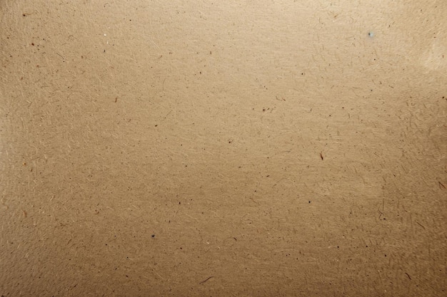 Background of brown kraft sheet paper or cardboard texture Pattern of beige rough carton