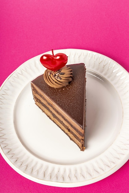 Background of chocolate cake with heart candle for Valentine's Day