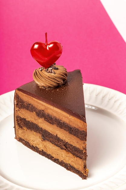 Background of chocolate cake with heart candle for Valentine's Day