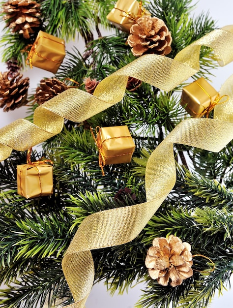 Background Christmas tree decorated with gifts and cones