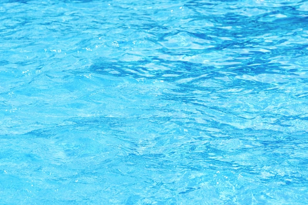 Background of clean blue rippled water in a hotel swimming pool