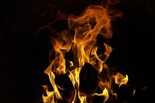 Background of the flame in the oven Tongues of fire in a brick fireplace Fire texture