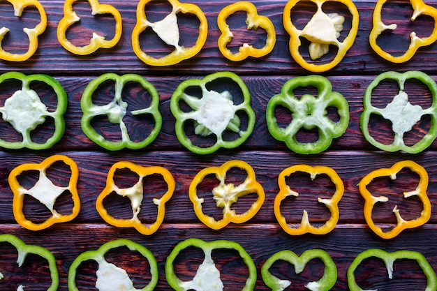 Background of fresh sliced peppers on wooden background