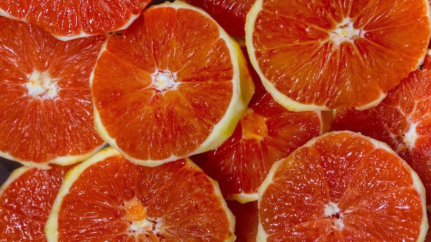 Background of fresh sliced sliced and peeled grapefruit fruits. Top view