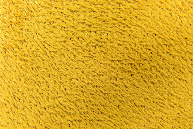 Background from fleecy fabric of yellow synthetic wool