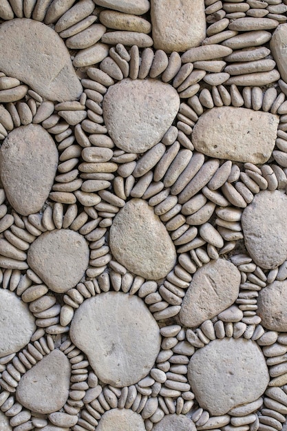 Background from high detailed fragment pebble stone wall texture close up