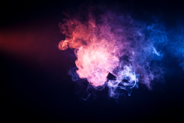 Photo background from pink and  blue  smoke of vape on black isolated