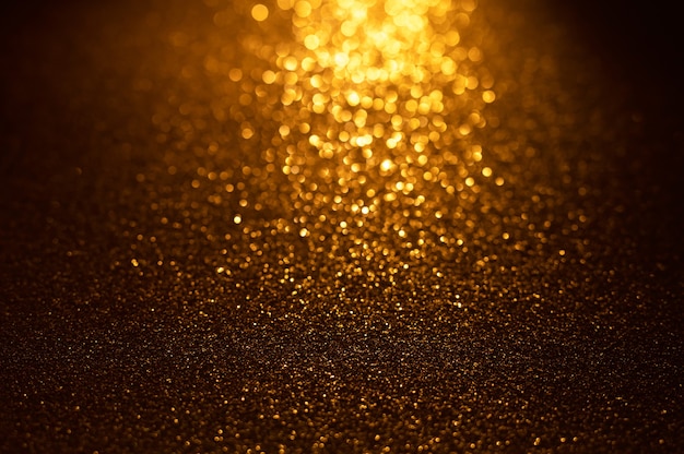 Background of gold and black glitter lights Defocused abstract background