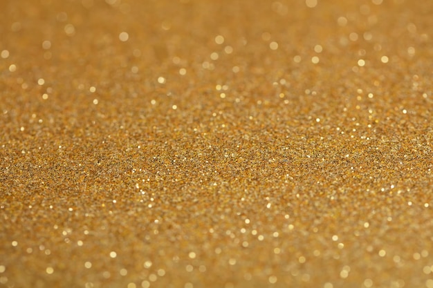 Background golden sparkles with bokehGilded paper for background