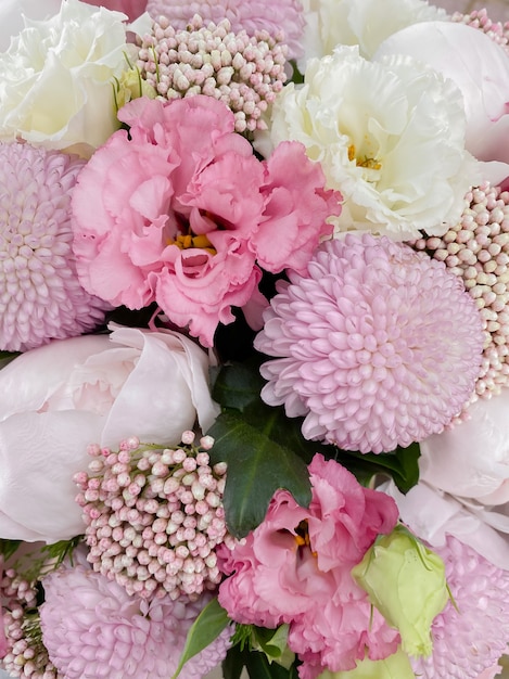 Background image of a beautiful flowers closeup The bouquet of peonies eustoma chrysanthemum