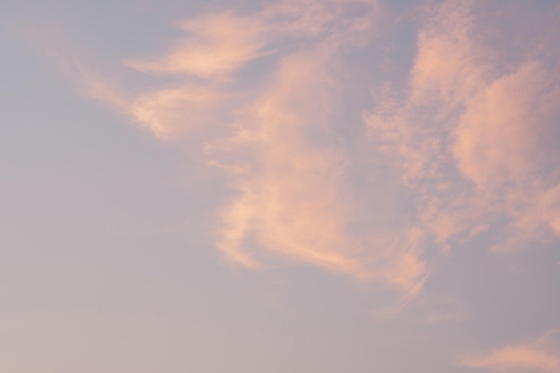 Background image of blue bright sky with pastel pink and white clouds Beautiful sky pattern on clear sunny day