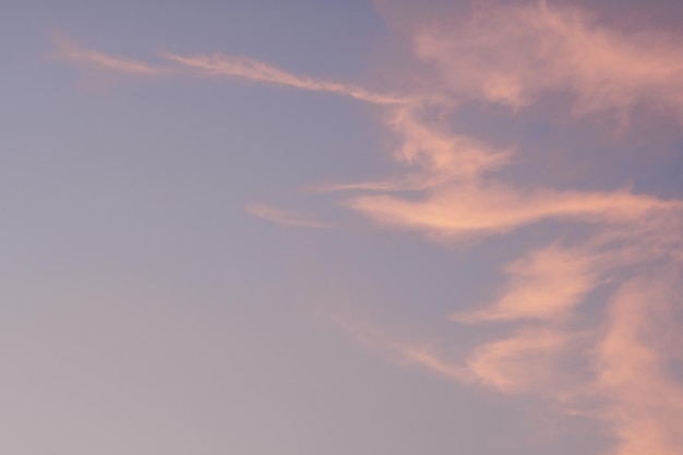 Background image of blue bright sky with pastel pink and white clouds Beautiful sky pattern on clear sunny day