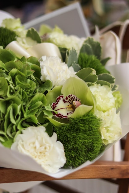 Background image of bouquet of flowers with white and green hydrangea eustoma cymbidium orchids