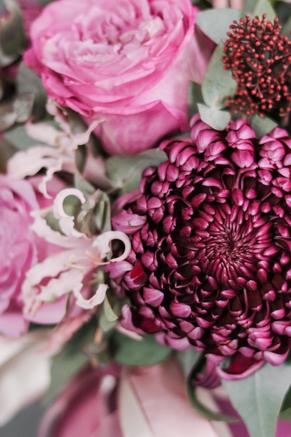 Background image of a delicate bouquet of flowers closeup in violetpink shades