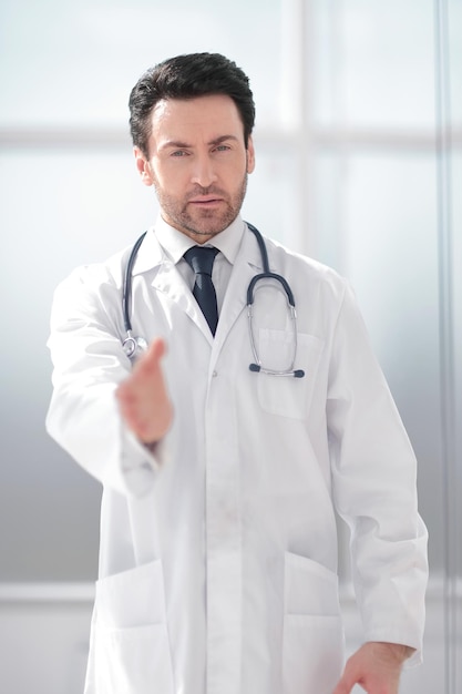 Background image of the doctor holding out his hand for greeting photo with copy space