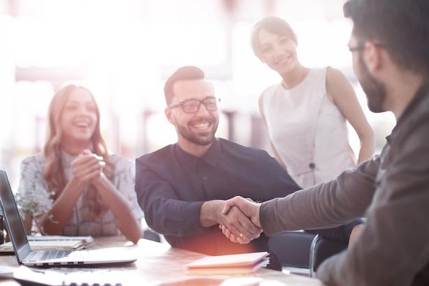 Background image of the handshake of business partners in the office