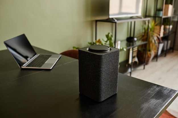 Background image of smart speaker with voice control home AI system on black table copy space