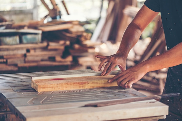 Background image of woodworking workshop: carpenters work table with wood cutting stand