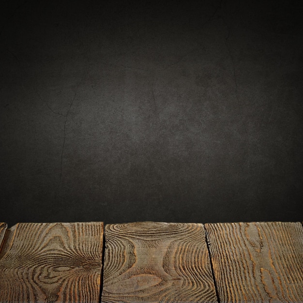 The background is blank wooden boards and a textured plastered wall with lighting and vignetting