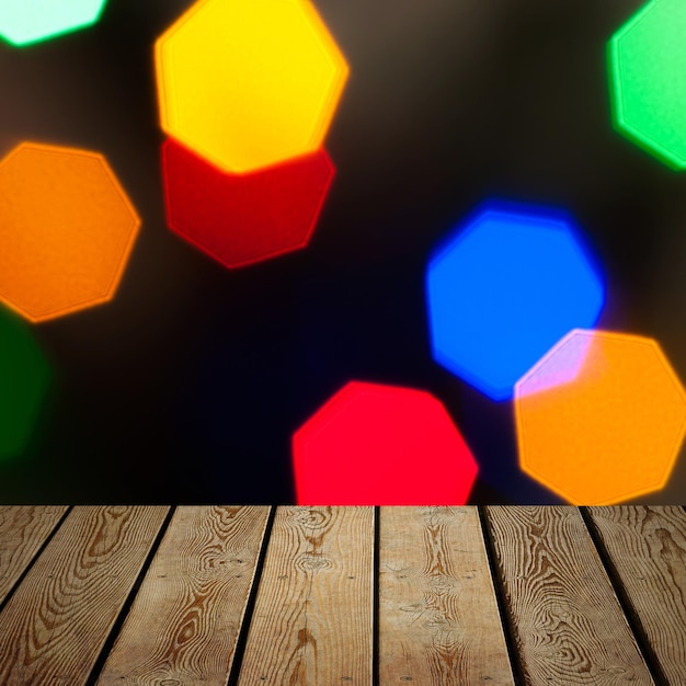 The background is an empty wooden board and a wall of blurred bokeh lights