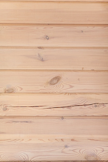 The background is a wall made of wooden beams.Texture for your design. Wooden beam and board. Background for still life. Beautiful wood texture.