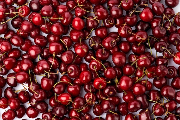 Background made of sweet cherry fruits isolated on white