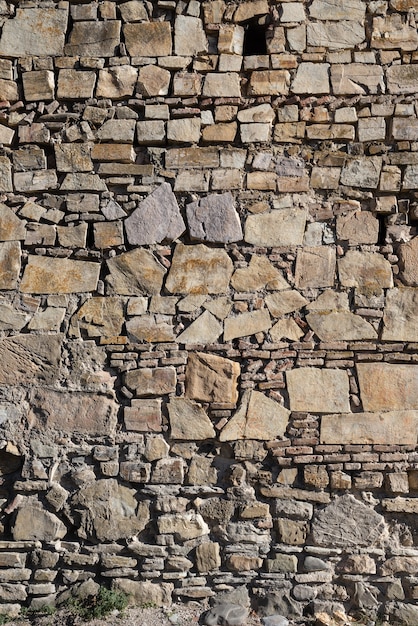 Background, many stones lie on each other, a wall of stone.