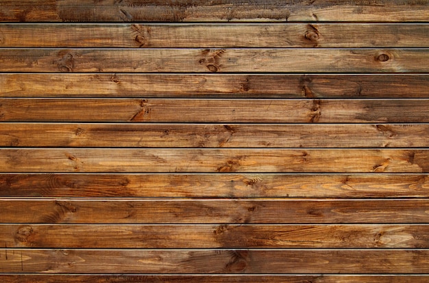 Background of natural knotted wood fence. Wooden texture.